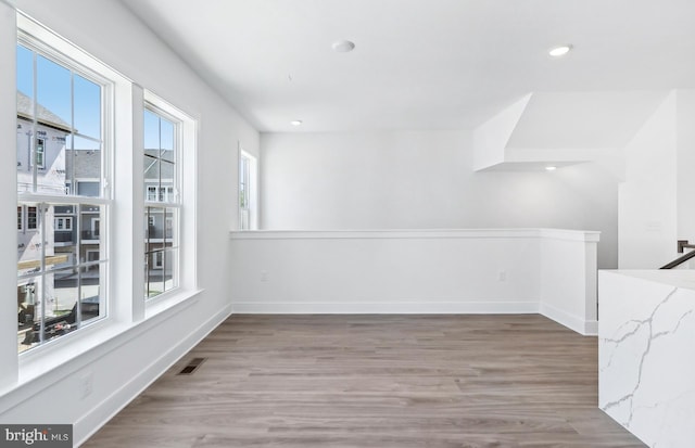 10812 Willow Ter, Fairfax, VA 22030 - unfurnished room featuring plenty of natural light, wood finished floors, baseboards, and recessed lighting