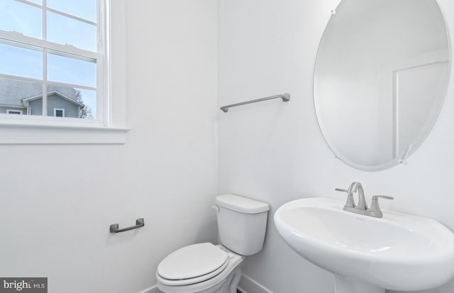 10812 Willow Ter, Fairfax, VA 22030 - bathroom featuring baseboards, a sink, and toilet