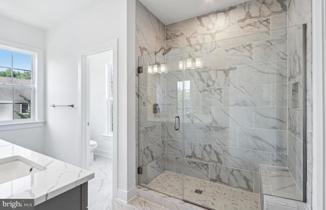 10812 Willow Ter, Fairfax, VA 22030 - bathroom with marble finish flooring, a stall shower, vanity, and toilet