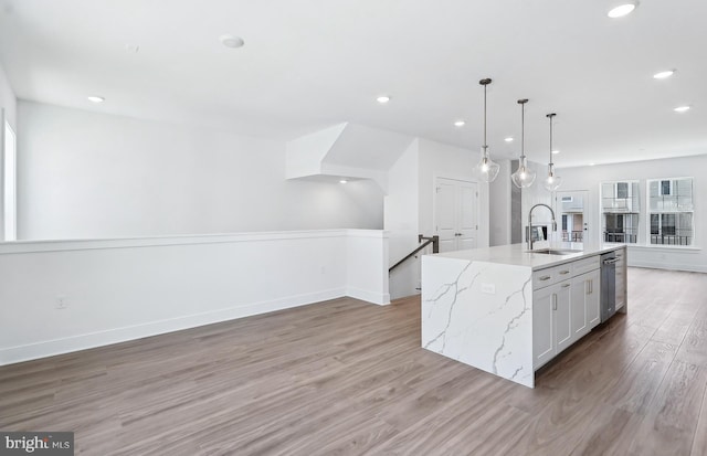10812 Willow Ter, Fairfax, VA 22030 - kitchen featuring a sink, light wood-style floors, recessed lighting, a center island with sink, and light stone countertops