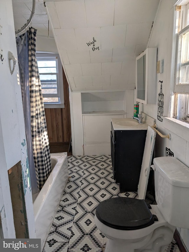 bathroom featuring vanity, toilet, and shower / bath combination with curtain