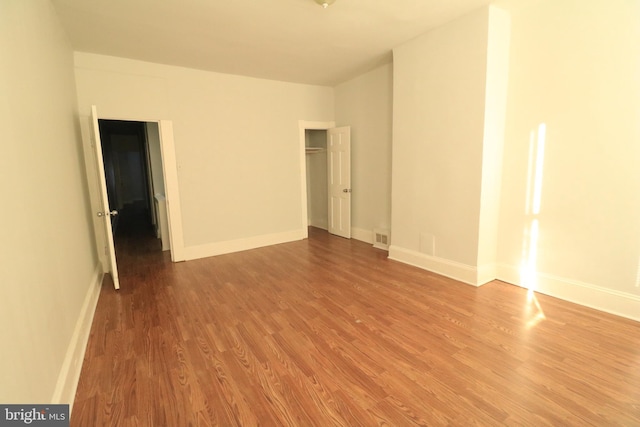 unfurnished room featuring wood-type flooring