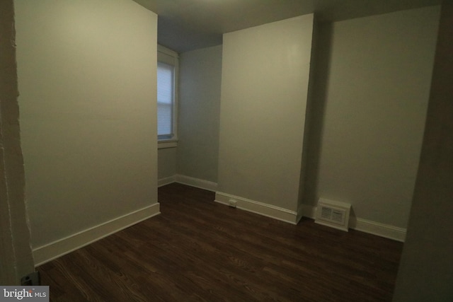 spare room featuring dark hardwood / wood-style floors