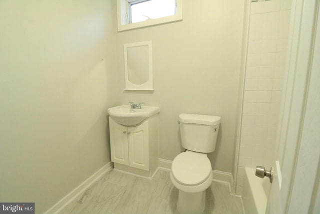 bathroom featuring walk in shower, vanity, and toilet