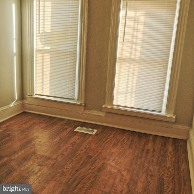2032 E N Ave, Baltimore, MD 21213 - empty room featuring dark wood-style flooring, baseboards, and visible vents
