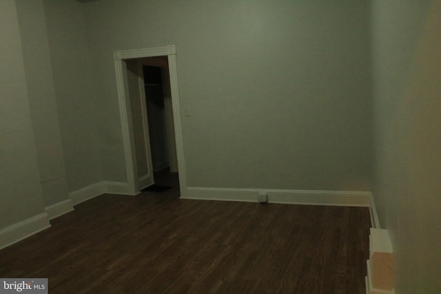 empty room with dark wood-type flooring