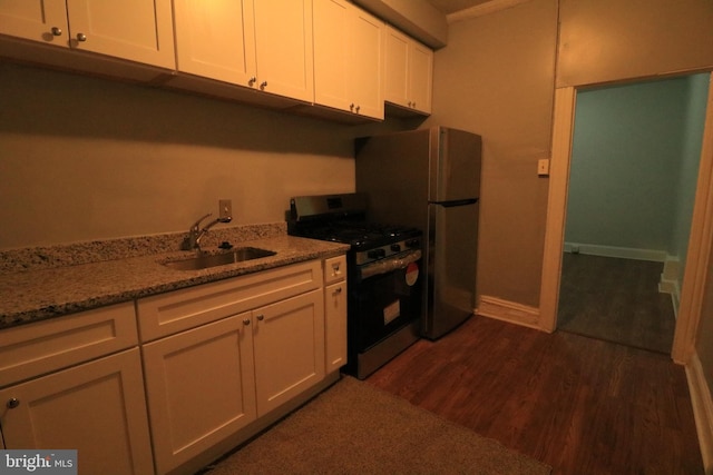 kitchen with sink, white cabinets, stainless steel fridge, black range with gas stovetop, and dark hardwood / wood-style flooring