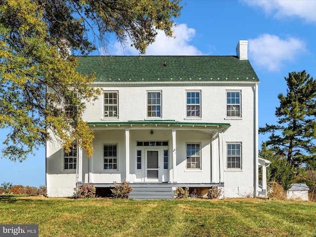 view of front of home featuring a front yard and a porch