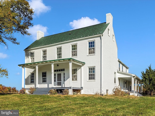 view of front of home with a front yard and a porch