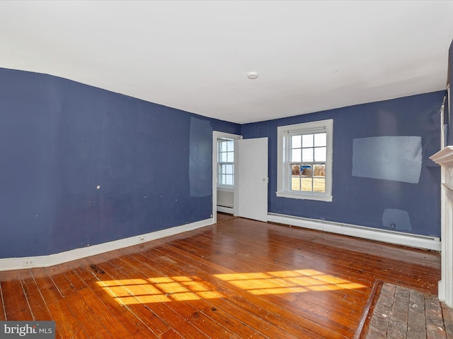 spare room with hardwood / wood-style flooring and baseboard heating