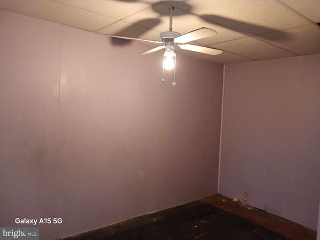 spare room featuring ceiling fan and a drop ceiling