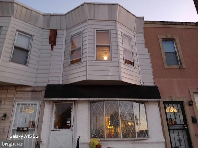 view of outdoor building at dusk