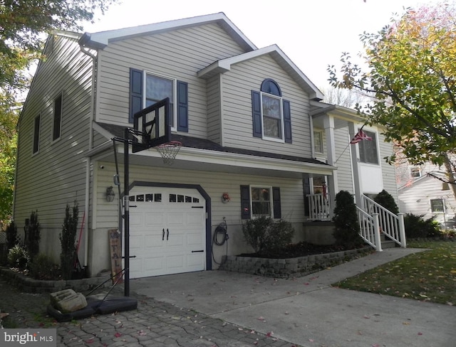 view of front of property featuring covered porch and a garage