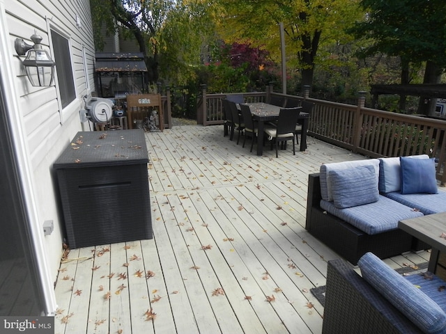 wooden terrace featuring outdoor lounge area