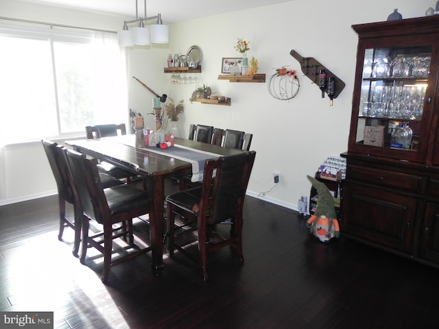 dining area with dark hardwood / wood-style flooring