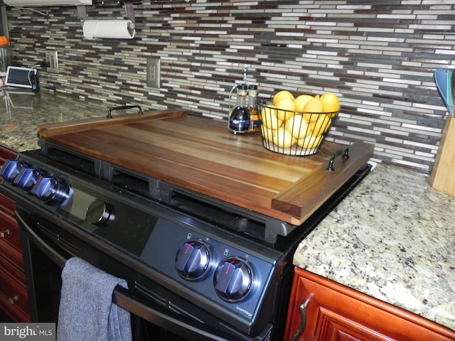 room details featuring backsplash and black electric range oven