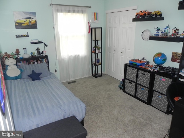 bedroom with a closet and light colored carpet