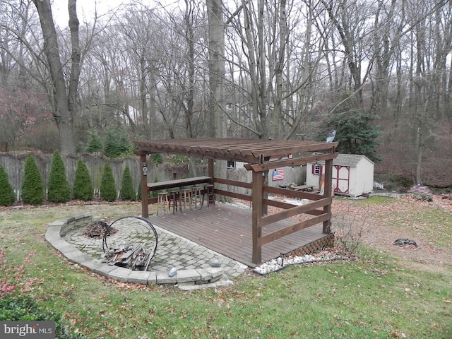 wooden deck featuring a pergola, a shed, and a lawn