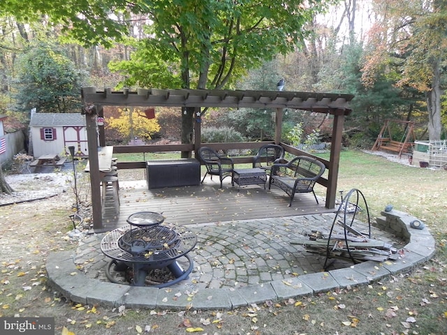 view of patio / terrace featuring a deck and a storage shed