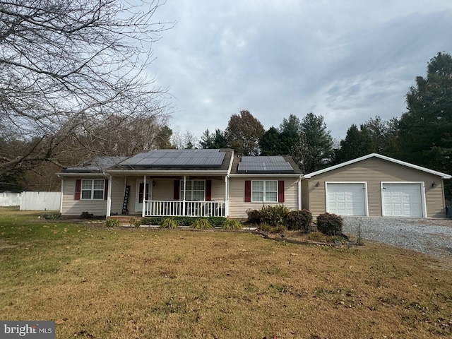 single story home with a front yard, covered porch, a garage, and solar panels