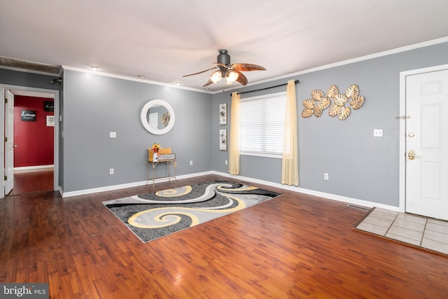 misc room featuring crown molding, ceiling fan, and dark hardwood / wood-style floors