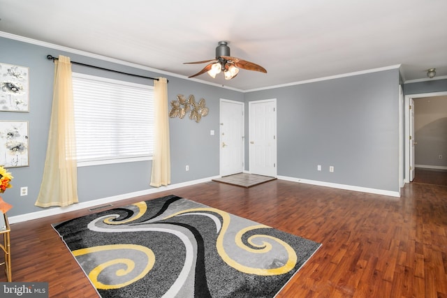 interior space with ceiling fan, dark hardwood / wood-style flooring, and crown molding