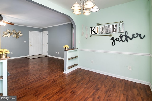 entrance foyer with crown molding, dark wood-type flooring, and ceiling fan with notable chandelier