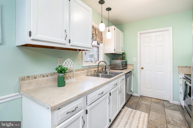 kitchen featuring white cabinets, decorative light fixtures, sink, and stainless steel appliances