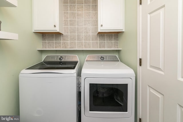 laundry area with cabinets and washing machine and dryer