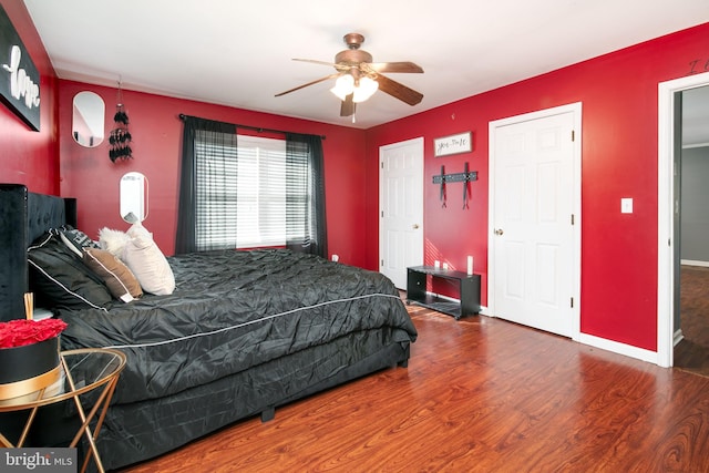 bedroom featuring dark hardwood / wood-style flooring and ceiling fan