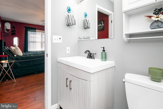 bathroom featuring hardwood / wood-style flooring, vanity, and toilet