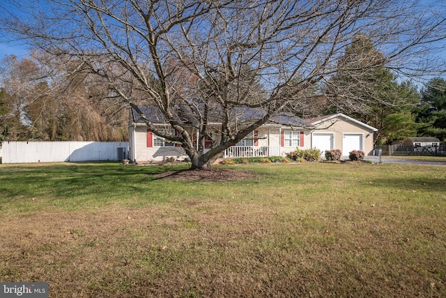 view of front of property with a garage and a front yard