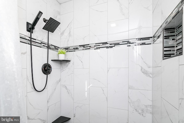 bathroom with a tile shower