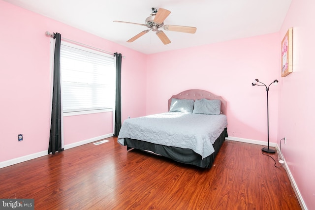 bedroom with ceiling fan and hardwood / wood-style flooring