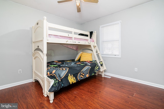 bedroom with dark hardwood / wood-style flooring and ceiling fan