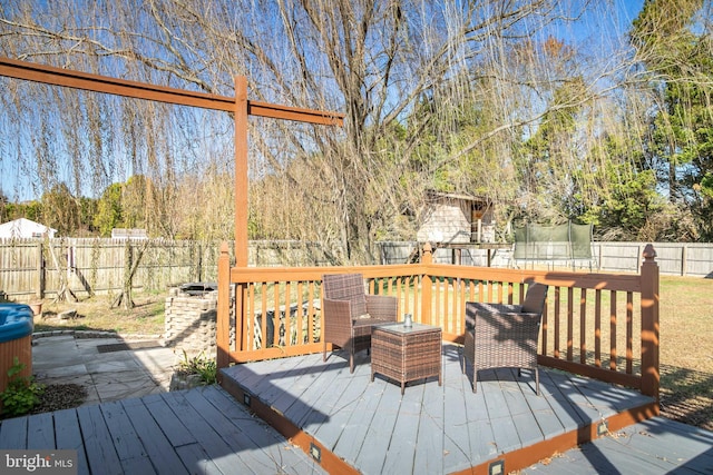 wooden deck featuring a trampoline