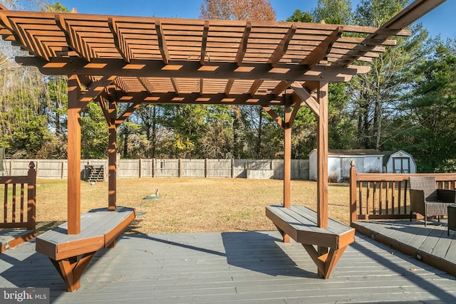 deck with a pergola, a yard, and a shed