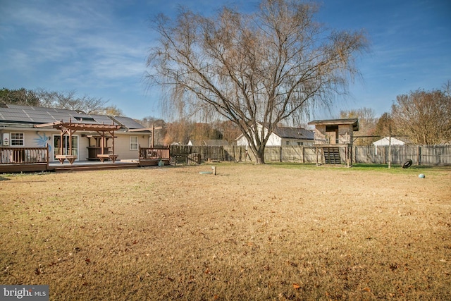 view of yard with a deck and a pergola