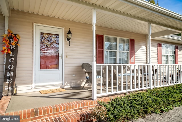 view of exterior entry with covered porch