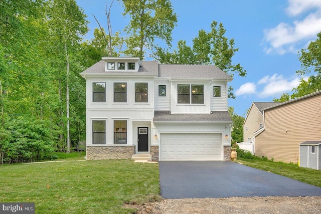 view of front of house featuring a garage and a front lawn