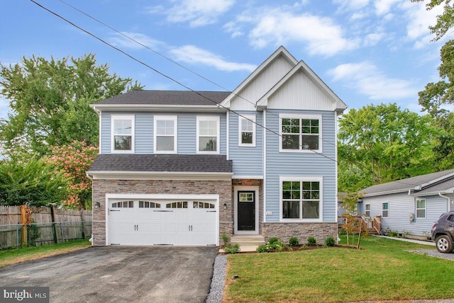 view of front of house featuring a garage and a front lawn