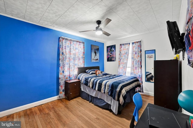 bedroom featuring light hardwood / wood-style flooring and ceiling fan