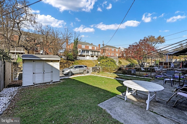 view of yard featuring a patio area and a storage shed