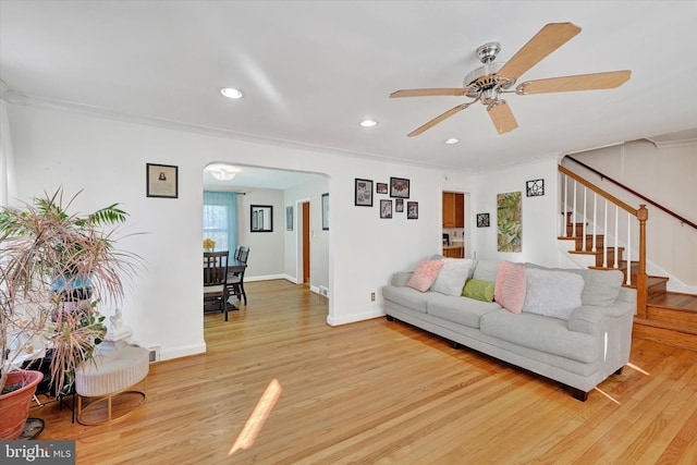 living room with ceiling fan and light wood-type flooring