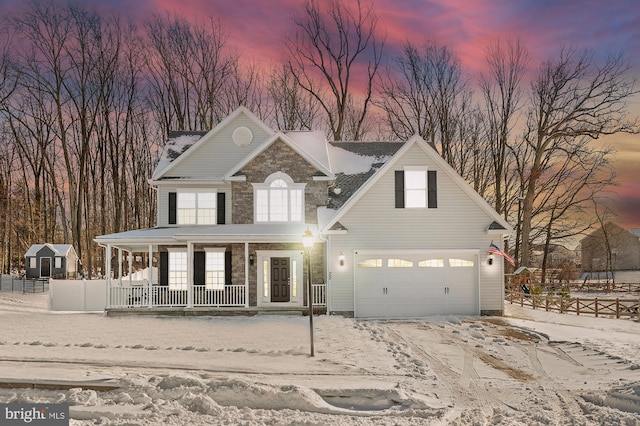 view of property featuring covered porch and a garage