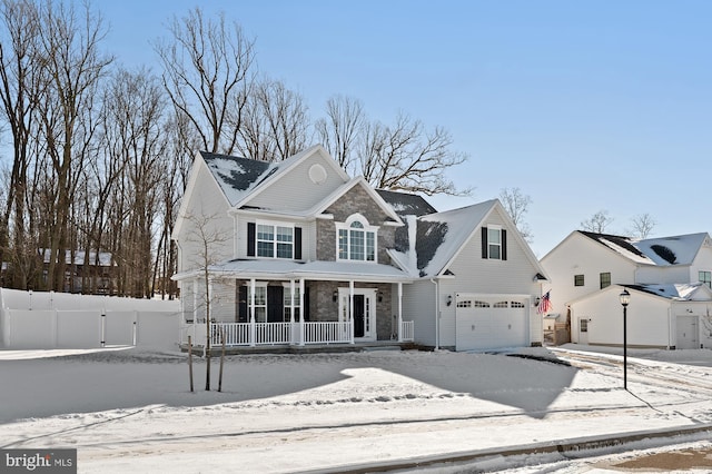 view of front facade featuring a porch and a garage