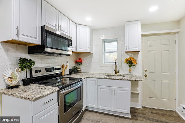 kitchen featuring appliances with stainless steel finishes, sink, and white cabinets