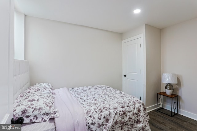 bedroom with dark wood-type flooring