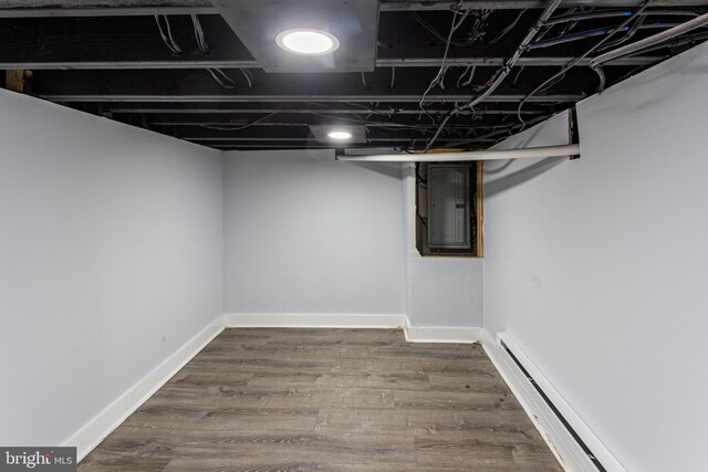 2544 N Gratz St, Philadelphia, PA 19132 - finished basement featuring a baseboard heating unit, electric panel, wood finished floors, and baseboards