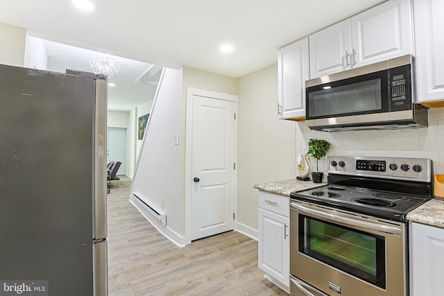 kitchen featuring stainless steel appliances, light hardwood / wood-style floors, baseboard heating, backsplash, and white cabinets